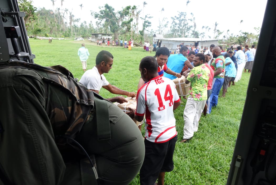 Villagers help unload. It is the first aid drop to this Taveuni village.