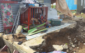 Washed away foundations and cot with salavaged belongings