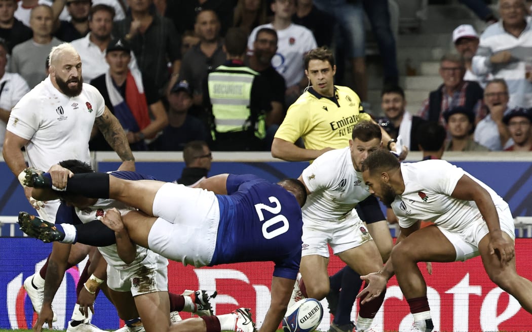 Samoa's flanker Alamanda Motuga (C) is tackled during the France 2023 Rugby World Cup Pool D match between England and Samoa at the Stade Pierre-Mauroy in Villeneuve-d'Ascq, near Lille, northern France on October 7, 2023. (Photo by Sameer Al-Doumy / AFP)