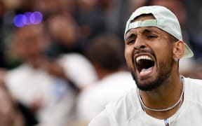 Australia's Nick Kyrgios celebrates beating Greece's Stefanos Tsitsipas during their men's singles tennis match on the sixth day of the 2022 Wimbledon Championships at The All England Tennis Club in Wimbledon, southwest London, on July 2, 2022. (Photo by Glyn KIRK / AFP) / RESTRICTED TO EDITORIAL USE