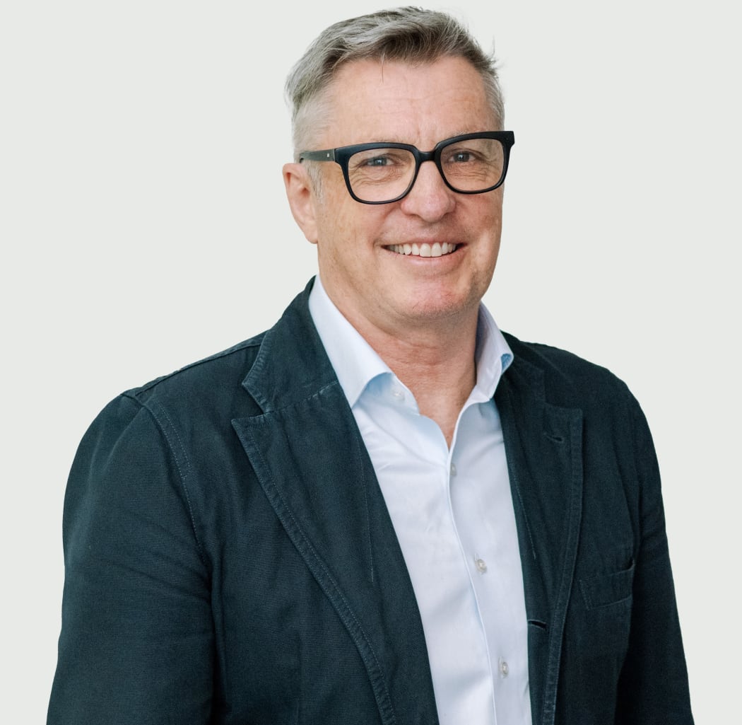 Photo of a man smiling at the camera.