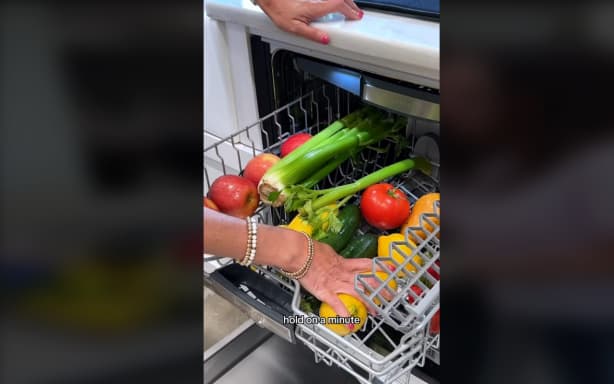 Screenshot from video on TikTok of person washing fruit and vegetables in dishwasher.