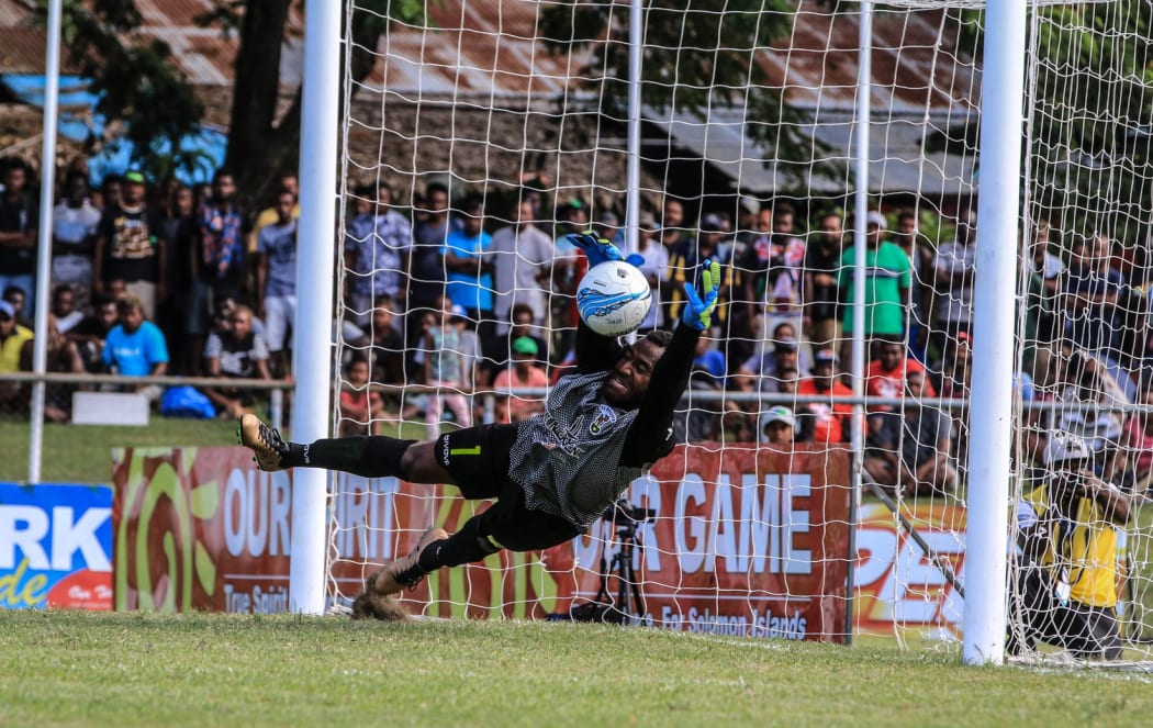 AS Magenta goalkeeper Steeve Ixoee saves a first half penalty.