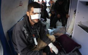 A wounded Palestinian arrives in the back on an ambulance at the Al-Shifa hospital in Gaza City, after patients were transported from the Kamal Adwan Hospital, on December 28, 2024, amid the ongoing war between Israel and the Hamas militant group. - Gaza health officials said on December 28, that Israeli forces detained the director of a hospital in the north, which the World Health Organization said was put out of service by an Israeli raid. On December 27, the Israeli military said it had launched an operation in the area of Kamal Adwan Hospital, alleging the facility was a "key stronghold for terrorist organisations". (Photo by Omar AL-QATTAA / AFP)