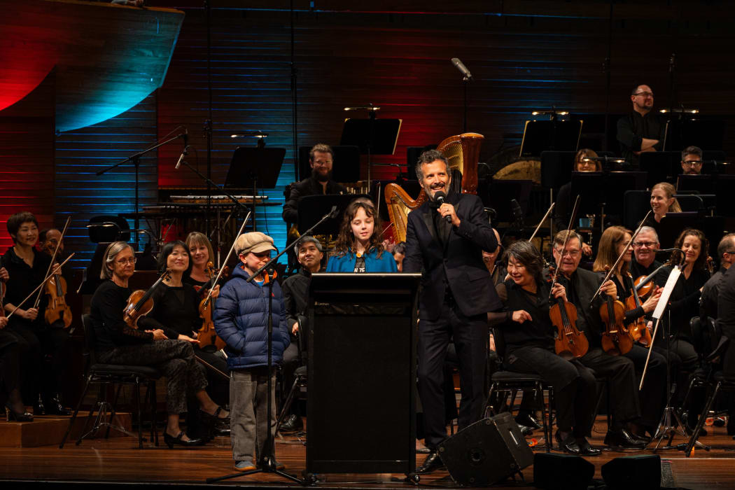 Bret McKenzie, host of the Creepy-Crawly Carnival, with two young members of the audience at the first show in Wellington