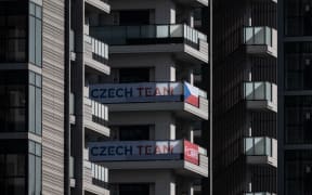 A Czech Republic flag and signage is displayed at the Olympic Village in Tokyo.
