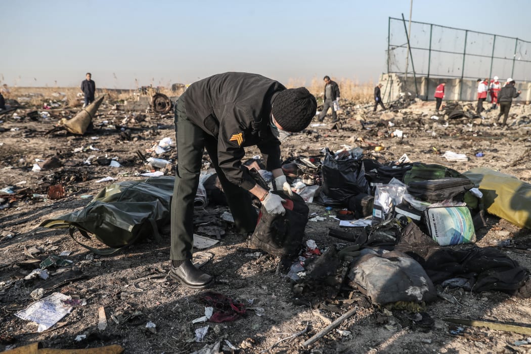 Rescuers search debris after a Ukrainian airplane carrying 176 people crashed on Wednesday shortly after takeoff from Tehran airport