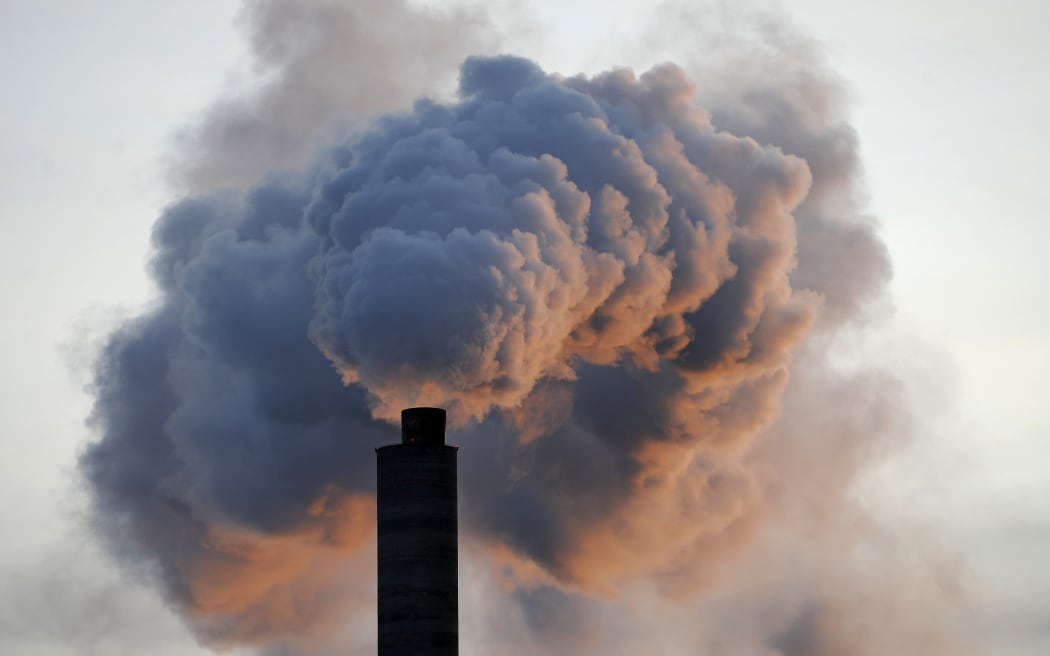 In a file picture taken on 2 January 2009, heavy smoke billows from the chimney of the Kraft paper factory in Pietarsaari, Finland.