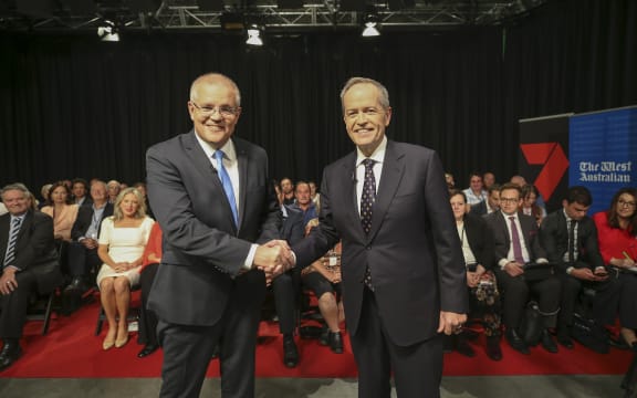 Australia's Prime Minister Scott Morrison (L) and opposition leader Bill Shorten shake hands before the first televised leaders debate in Perth.
