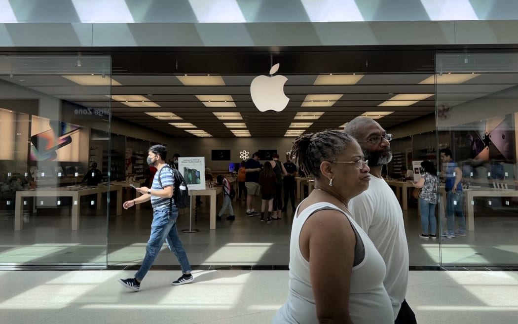 TOWSON, MARYLAND - JUNE 20: People walk past The Apple Store at the Towson Town Center mall, the first of the company's retail locations in the U.S. where workers voted over the weekend to unionize, on June 20, 2022 in Towson, Maryland. Following a late-pandemic era wave of workers demanding higher pay, better benefits and more negotiating leverage, 65 of the 98 workers at the Towson Apple Store voted to join the International Association of Machinists and Aerospace Workers union on June 18.   Chip Somodevilla/Getty Images/AFP (Photo by CHIP SOMODEVILLA / GETTY IMAGES NORTH AMERICA / Getty Images via AFP)