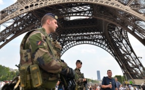 France is already under a state of emergency. Here, soldiers patrol the Eiffel Tower, in Paris.