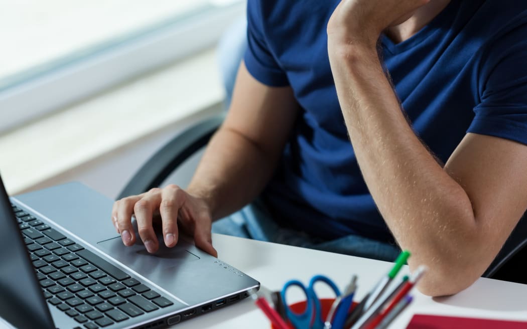 Horizontal view of man working on laptop