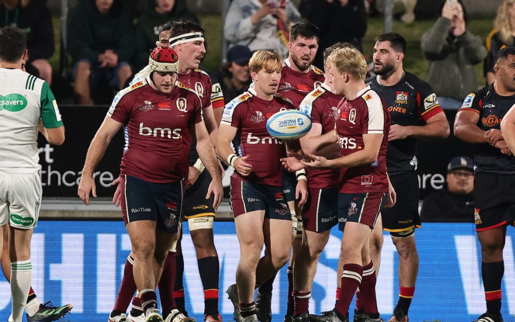 Tate McDermott of the Reds celebrates a try.