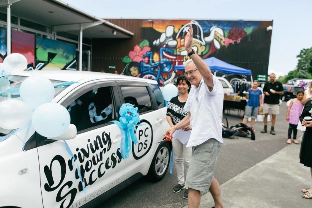 Harry Doig, Puketāpapa Local Board chairman, cutting the ribbon for one of Puketāpapa Community Driving School’s vehicles on its opening day.