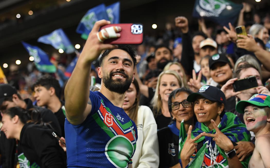 Shaun Johnson of the Warriors poses for selfies with fans after the NRL Preliminary Final match between Brisbane Broncos and New Zealand Warriors at Suncorp Stadium