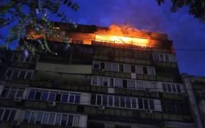 A fire burns at a residential building in Kyiv.
