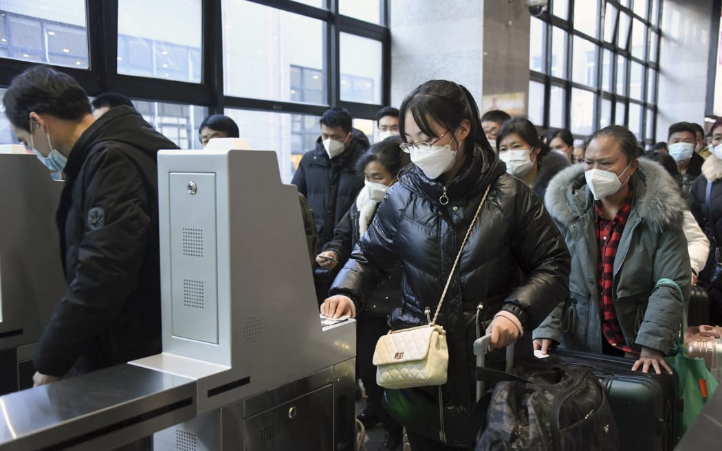 Passengers go through automatic ticket gates at Beijing West Railway Station in Beijing, capital of China, 7 January 2023. The 40-day Spring Festival travel rush in China kicked off Saturday.