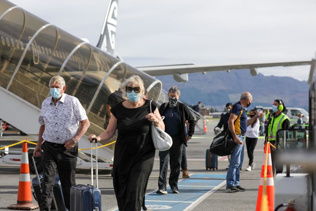 Passengers arriving in Queenstown on the first flight from Auckland on 15 December 2021.