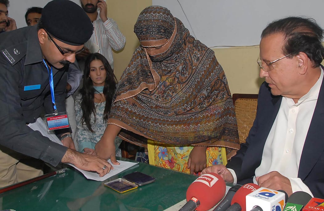 Asia Bibi, a Christian mother thums on her appeal papers against a death sentence