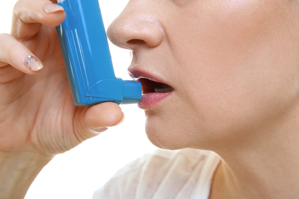 Adult woman using inhaler