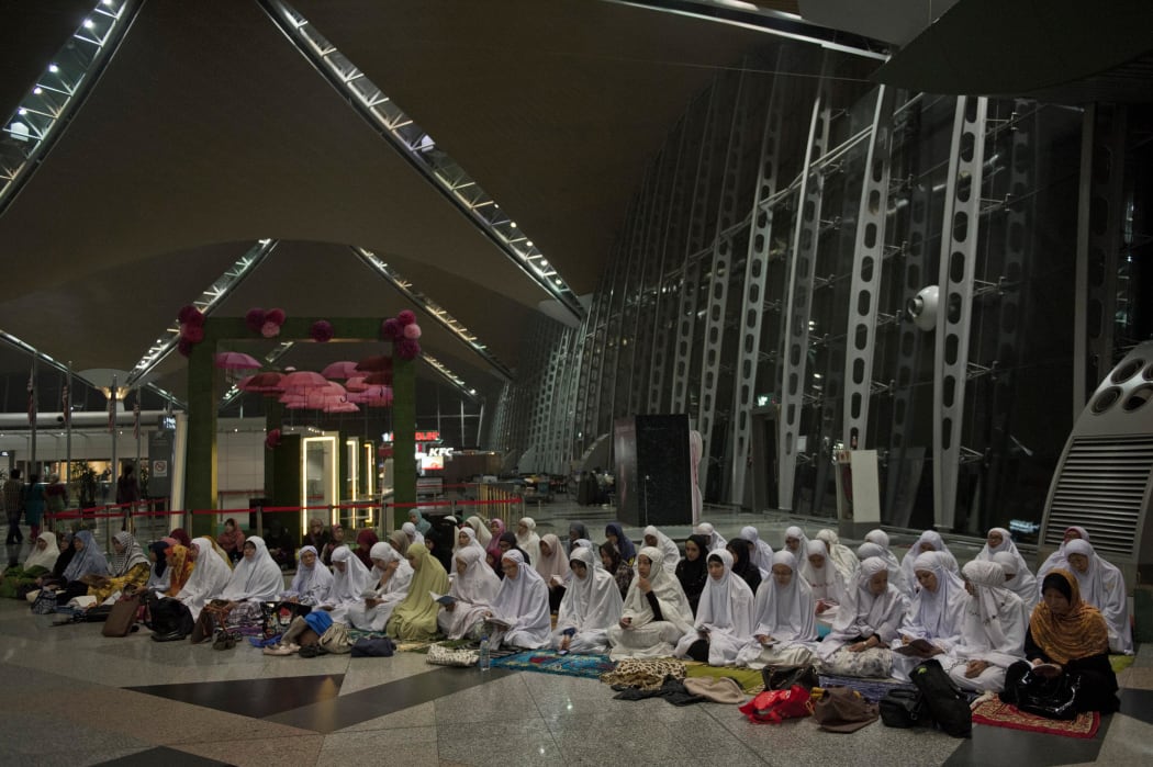 Muslim Malaysians pray at Kuala Lumpur International Airport.