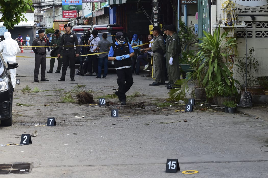 Thai police gather evidence evidence after one of a string of bombs exploded in the resort town of Hua Hin.