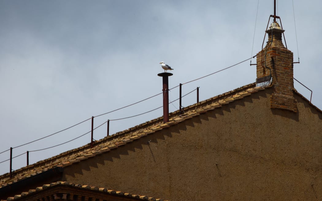 A seagull is seen sitting on a Sistine Chapel chimney on the first day of the conclave during which the cardinals will elect the new pope. Vatican City, Vatican on May 7th, 2025. (Photo by Beata Zawrzel/NurPhoto) (Photo by Beata Zawrzel / NurPhoto / NurPhoto via AFP)