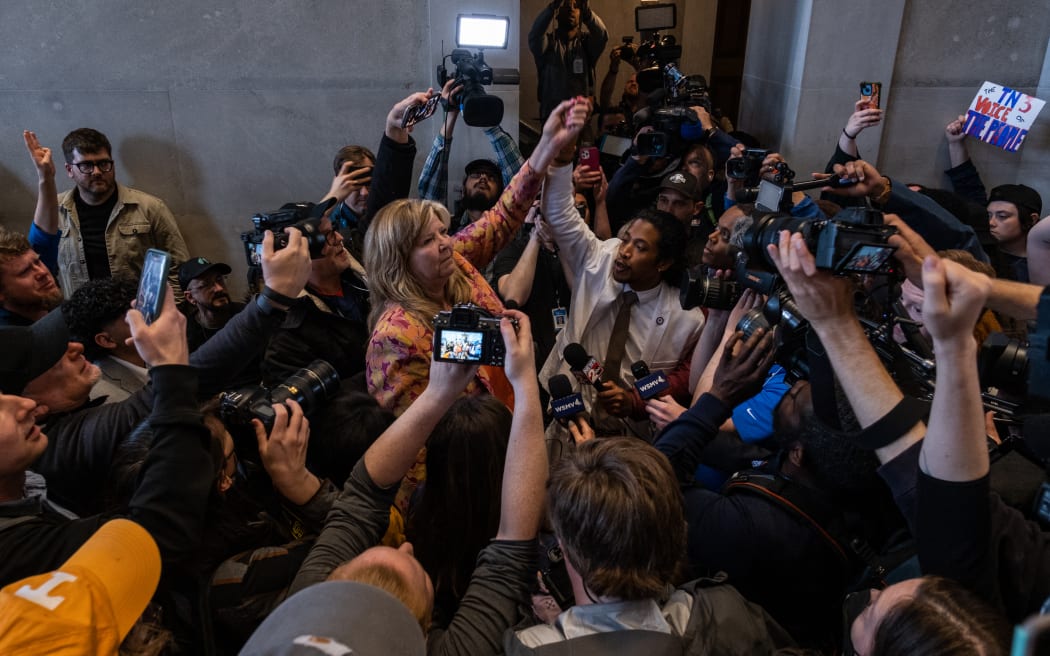 NASHVILLE, TN - APRIL 06: Democratic state Reps. Gloria Johnson of Knoxville and Justin Jones of Nashville raise their arms in defiance after a vote that expelled Jones from the governing body on April 6, 2023 in Nashville, Tennessee. Jones was expelled after he, Johnson and Rep. Justin Pearson of Memphis led a protest at the Tennessee State Capital building in the wake of a mass shooting at a Christian school in which three 9-year-old students and three adults were killed by a 28-year-old former student of the school on March 27. Johnson and Pearson also face expulsion.   Seth Herald/Getty Images/AFP (Photo by Seth Herald / GETTY IMAGES NORTH AMERICA / Getty Images via AFP)