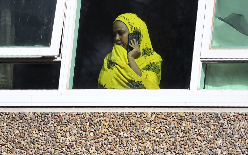 A resident looks from a window at one of nine public housing estates locked down due a spike in COVID-19 coronavirus numbers in Melbourne on July 6, 2020.