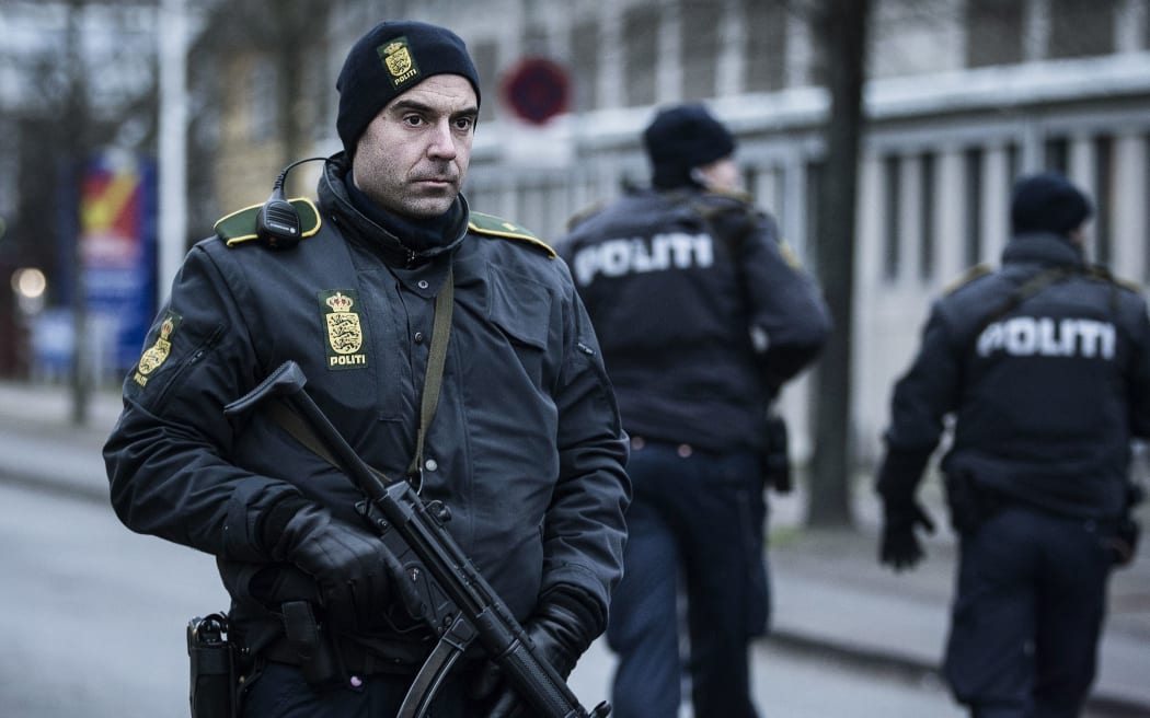 A police officer guards the street around the Noerrebro train station in Copenhagen.