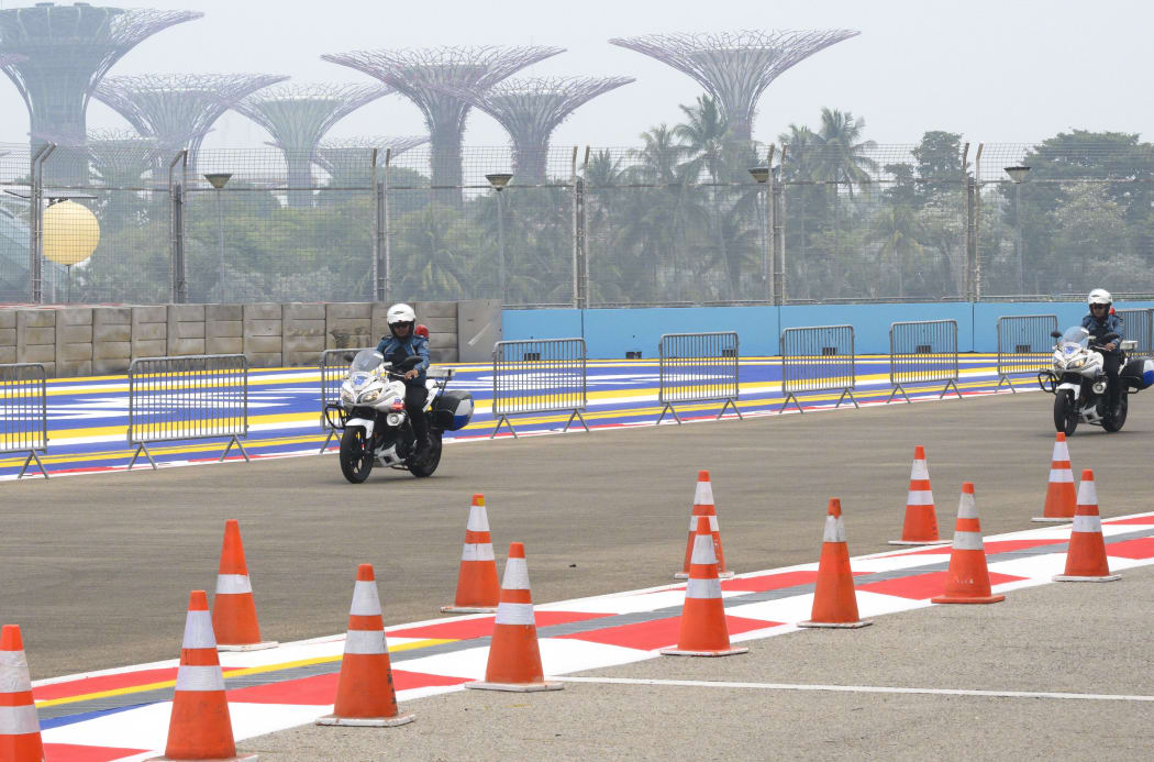 Mounted police ride on the race track of Formula One Singapore Grand Prix night race as haze blankets Singapore on September 18, 2019.