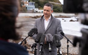 Climate Change Minister James Shaw speaks to media at Owhio Bay, which has been slammed by repeated storms, after revealing the National Adaptation Plan