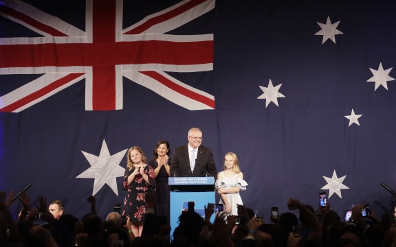 Australian Prime Minister Scott Morrison arrives to speak to party supporters flanked by his wife Jenny, and daughters Abbey, left, and Lily after his opponent Bill Shorten conceded defeat in the federal election.