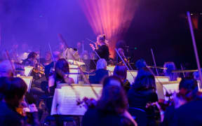Conductor Holly Mathieson with the NZSO and metal band Alien Weaponry in 2021