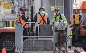 Fire investigators work at the scene following a fatal fire at Loafers Lodge in Wellington on 16 May, 2023.