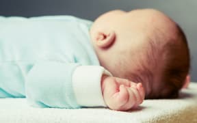 sleeping baby, focus on the hand