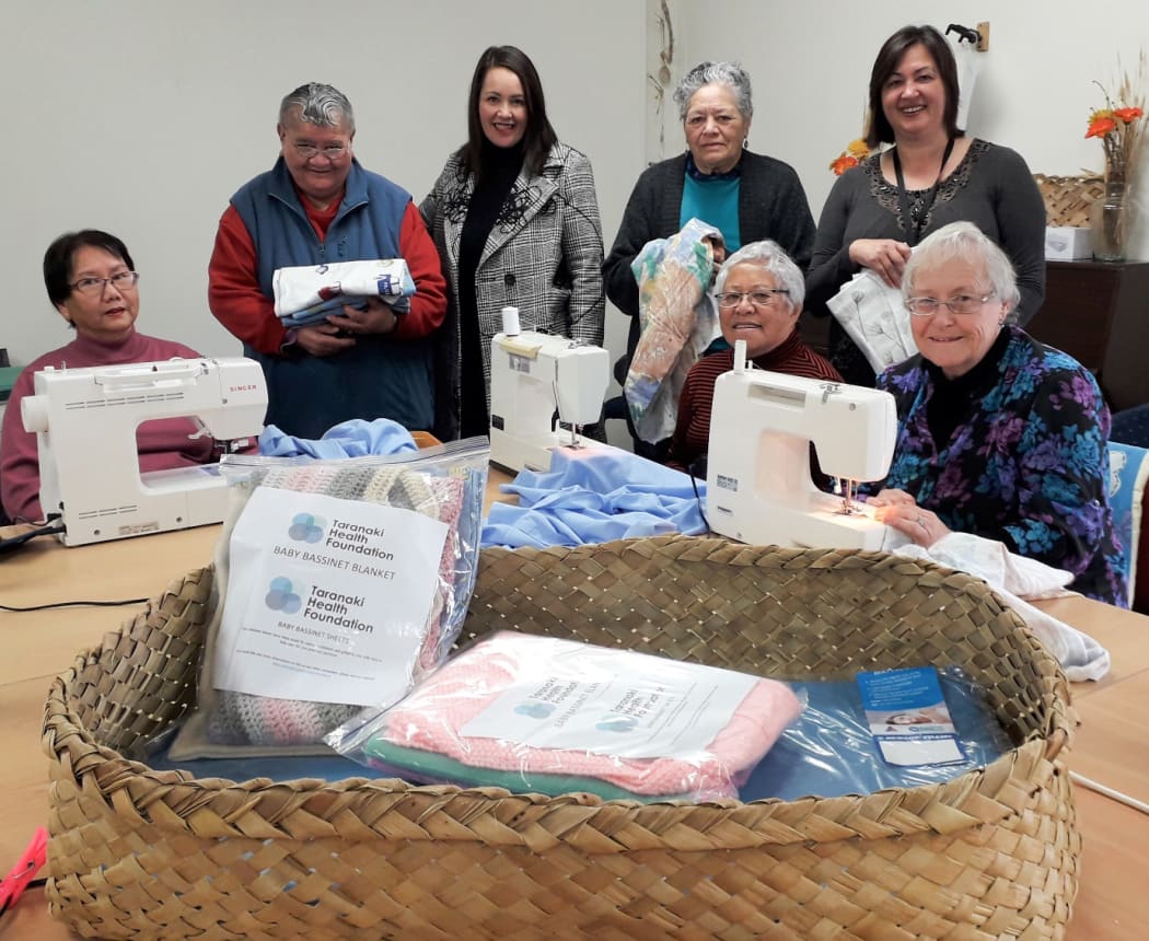 Mahia Mai A Whai Tara, pictured from left, Faye Joe, Gemma Wirihana, Bry Kopu-Scott (Taranaki Health Foundation general manager), Anna Kete, Kapuakore Harlow, Tasha Kupe (Taranaki Health Foundation administrator) and Lillian Hall, sewing baby sheets for use in Pepi Pods pictured in foreground.