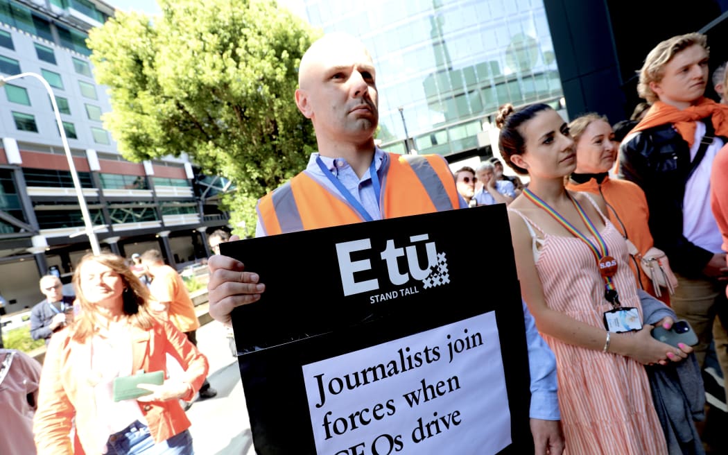 People attend a rally outside TVNZ headquarters in Auckland on 28 March, 2024 as part of a campaign protesting the broadcaster's planned job cuts.