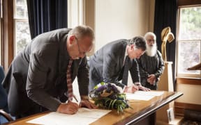 Sir Mark Solomon (front) and John Ward at the signing ceremony.