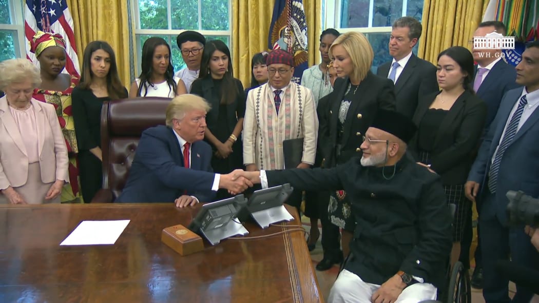 US President Donald Trump meeting with Christchurch mosque shooting survivor Farid Ahmed.