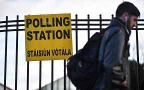 A man walks past a Polling Station in Dublin, Ireland on February 8, 2020, as voting gets under way in the Irish General election.
