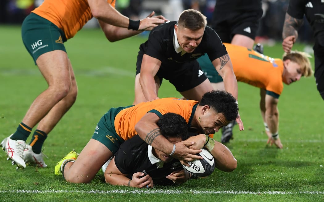 New Zealand's Caleb Clarke scores a try.