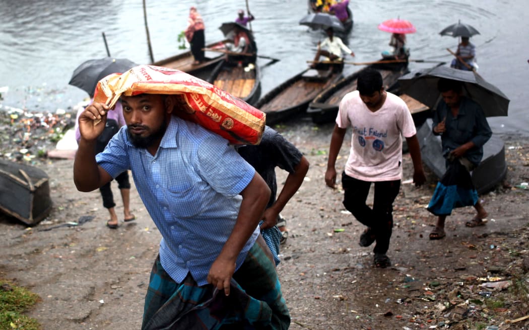 People make their move in a light rain during cyclone Bulbul In Dhaka, Bangladesh on 09 November 2019 . (Photo by Syed Mahamudur Rahman/NurPhoto)
