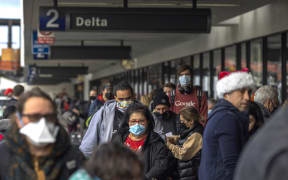 Travellers arrive at Los Angeles International Airport in Los Angeles, California, on December 23, 2021.