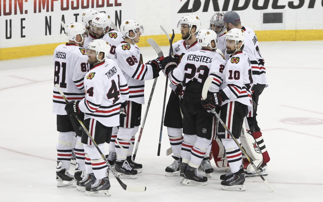 Blackhawks players celebrate their victory.