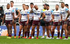 Manly players look on during a match against the Warriors.