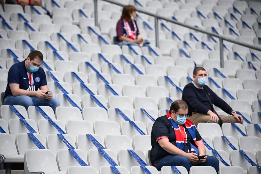 Football supporters  as attendence is limited for COVID-19 (novel coronavirus) safety measures prior to the French Cup final football match between Paris Saint-Germain (PSG) and Saint-Etienne (ASSE) on July 24, 2020, at the Stade de France in Saint-Denis, outside Paris.
