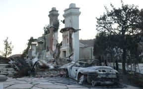 The burned entranceway to a damaged home, as the Los Angeles Palisades fire continues to spread, on 12 January, 2025, leaving thousands without homes.