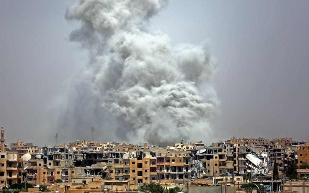 Smoke billows out from Raqqa following a US-led coalition air strike.