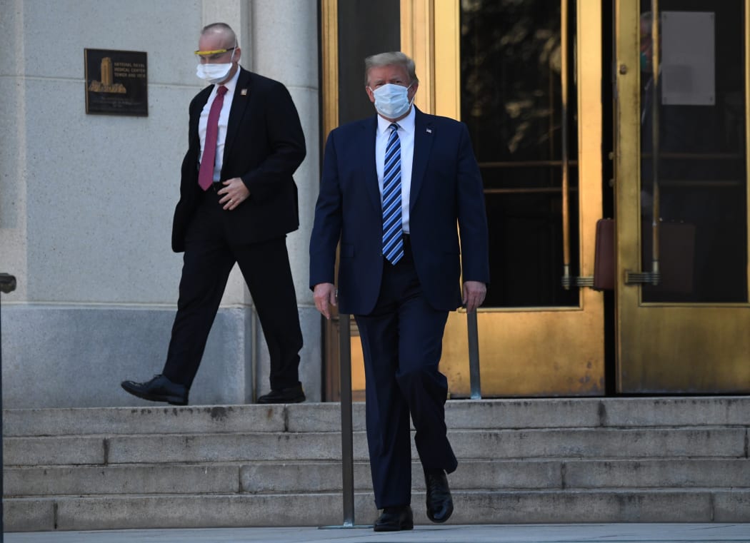 US President Donald Trump walks out of Walter Reed Medical Center in Bethesda, Maryland, to return to the White House.